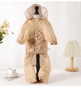 Detailed view of breathable polka dot pet raincoat with four-leg coverage and hood.