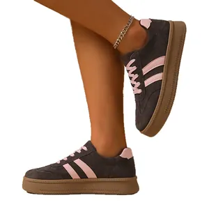 Vintage dark grey women's German training style sneakers with pink stripes and gum sole
