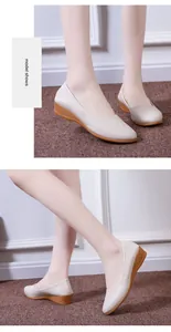 Detail view of beige soft leather wedge loafers with pointed toe for women.