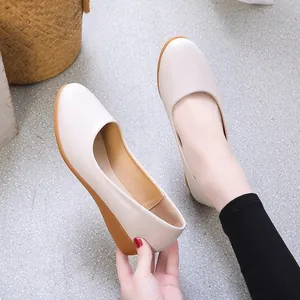 Minimalist beige faux leather flat shoes with comfortable brown rubber soles for women.