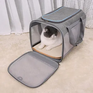 Detail of a washable pet pad inside a gray soft pet carrier with breathable mesh.