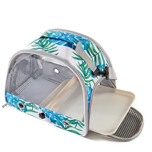 Detailed view of portable bird carrier bag with tropical leaf print and sliding tray