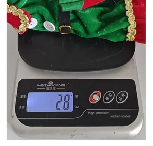 Detailed view of a Christmas elf wine bottle cover weighed on a digital scale at 28 grams