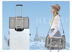 Gray foldable pet carrier bag shown on suitcase and carried by shoulder strap