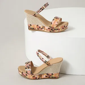 Detailed side view of ethnic floral print wedge sandals featuring woven straw texture details.