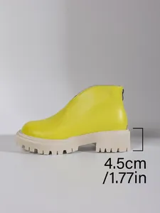 Close-up detail showing the 4.5cm chunky platform heel of the yellow ankle boots.
