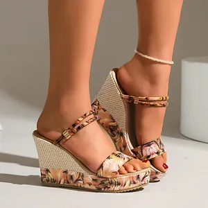 Close-up of wedge sandals with vibrant floral print and woven straw heel detail