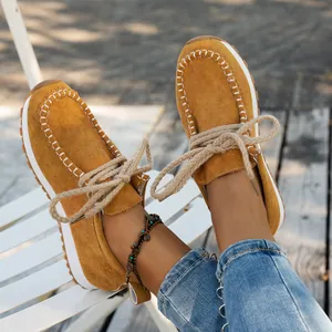 Close-up of mustard yellow suede loafers for women with thick stylish rope laces