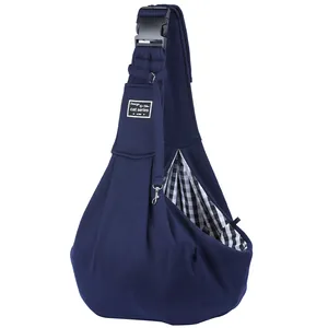 Detail of navy blue pet sling carrier with adjustable strap and checkered lining