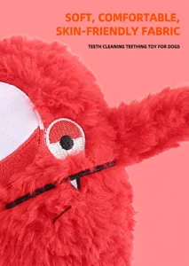 Macro detail of soft red plush monster dog chew toy showing teeth cleaning texture
