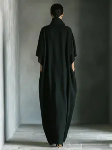 Back view of minimalist loose black maxi dress with elegant draped silhouette