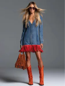 Stylish blue denim mini dress featuring red fringe tassels and a front zipper closure.