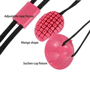 Mango-shaped dog tug toy with suction cup and durable rope for teething