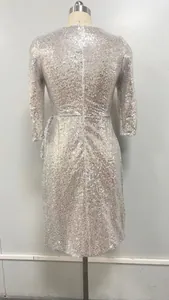Back view of an elegant silver sequin long sleeve mini dress for women