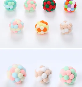 Detailed view of colorful plush pompom balls for cats in various vibrant patterns