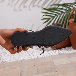 Close-up view showing the black textured anti-slip sole of burgundy flat sandals