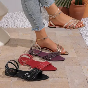 Close-up of elegant pointed-toe flat sandals in multiple colors and textures