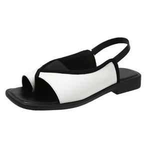Side-angle view showing the minimalist black and white square-toe slingback sandal