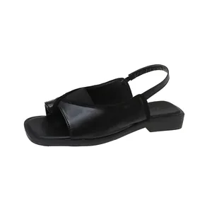 Detailed side view of black square-toe slingback sandals with low block heel