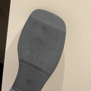 Close-up of non-slip rubber sole with horizontal grip pattern for flat sandals