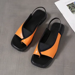 Detailed top-down view of orange and black square toe clip-toe slingback sandals