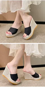 Vue latérale de sandales compensées noires pour femmes avec semelle en lin et orange