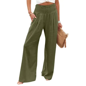 Close-up of olive green high-waist wide-leg pants featuring a smocked waistband