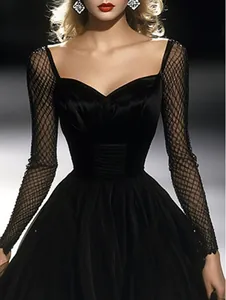 Detail of black vintage French evening dress with mesh sleeves and sweetheart neckline.