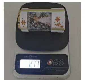 Christmas glowing snow globe lantern weighing 277 grams on a digital scale for detail