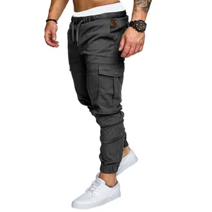 Detailed view of mens slim fit dark grey cargo pants with multi-pockets and drawstring.