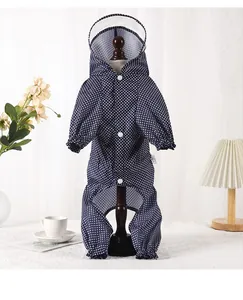 Macro view of blue polka dot four-legged dog raincoat with clear hood and buttons