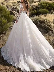Back view of elegant lace wedding dress with long sleeves and heavy floral train