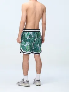 Back detail view of men's athletic lined sports shorts with green tropical leaf print
