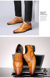 Detail of men's tan leather brogue oxfords with classic wingtip perforated patterns.