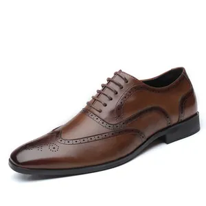 Classic men's brown Brogue formal leather shoes with lace-up detail on white background