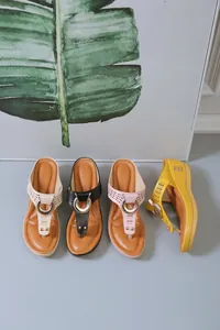 Detail view of women's wedge flip-flop sandals in four colors with hollow patterns