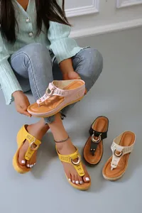Detailed view of women's wedge thong sandals with hollow patterns and various colors