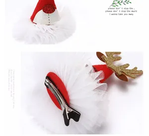 Detailed view of the Christmas hat hair clip showing the alligator clip and tulle.