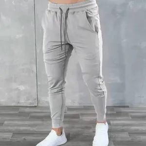 Close-up detail of men's gray athletic cotton blend joggers with drawstring waist