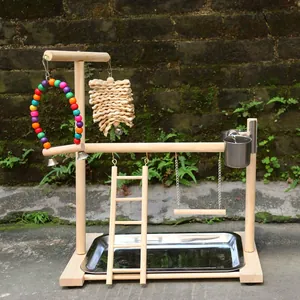 Detailed view of wooden bird playground stand with ladder, swing and stainless steel tray