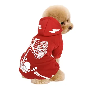 Rear view of a poodle wearing a red Halloween skeleton hoodie on a white background.