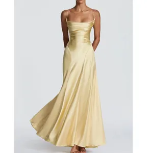 Professional front view of a yellow satin backless evening gown with pleated bodice details