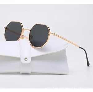 Detailed view of stylish octagonal metal sunglasses resting on a white leather case