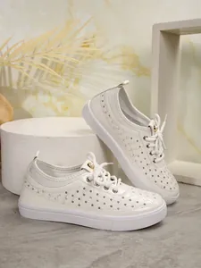 Close-up detail of white breathable microfiber leather sneakers with hollow out pattern
