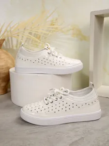 Detail view of white microfiber leather breathable casual sneakers with hollow mesh design.