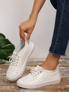White breathable faux leather sneakers with hollow-out pattern and sequin details