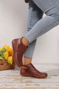 Elegante braune flache Stiefeletten aus Kunstleder mit Klettverschluss an den Füßen