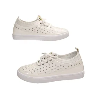 White breathable laser-cut faux leather sneakers with soft sole and lace-up closure