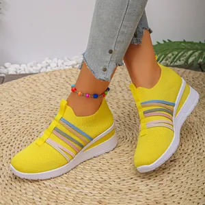 Detailansicht der gelben atmungsaktiven Fly-Woven-Keilsneaker für Damen mit Regenbogenriemen