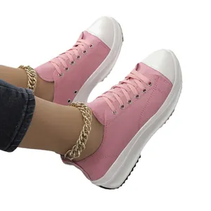 Baskets compensées en toile rose pour femmes avec des lacets et une semelle blanche.